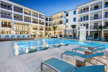 Resort inspired pool with sun shelf and poolside cabanas